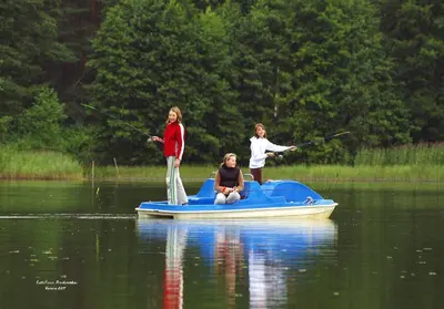 two girls on a small boat in the water at Sodyba Latkrantė, Druskininkai in Latežeris