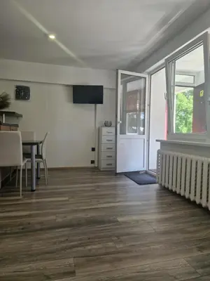 an empty living room with a table and a dining room at VK Duplex Apartment in Druskininkai