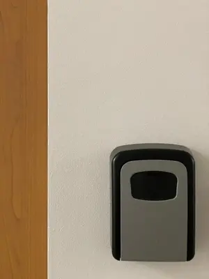 a black object is attached to a wall at Akva Apartament 1 in Druskininkai