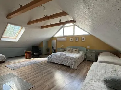 a attic bedroom with two beds and a window at Residence R&R in Karvys
