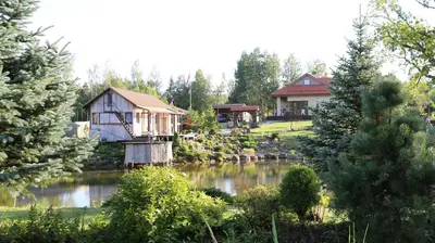 a couple of cottages next to a lake at Residence R&R in Karvys