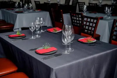 a table with wine glasses and red napkins on it at Greta in Druskininkai
