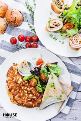two plates of food on a table with food at Greta in Druskininkai
