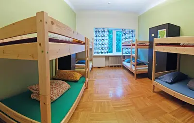 a room with three bunk beds in a room at The Monk's Bunk Kaunas in Kaunas