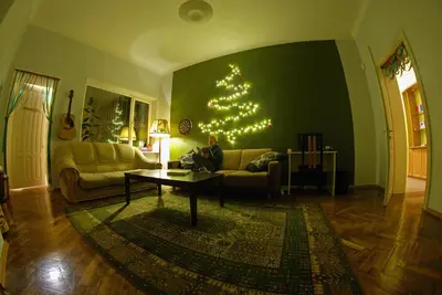 a living room with a christmas tree on the wall at The Monk's Bunk Kaunas in Kaunas