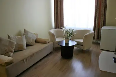 a living room with a couch and two chairs and a table at VESK Svečių Namai in Druskininkai
