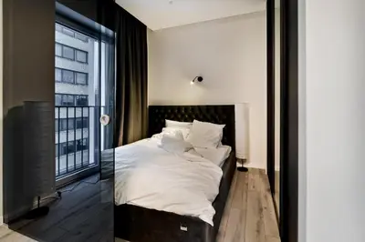 a bedroom with a large bed and a window at City Center Loft 2 in Kaunas