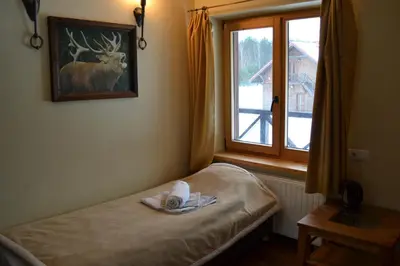 a room with a bed with a deer picture on the wall at sodyba 