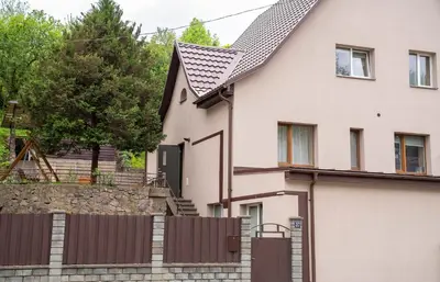 a house with a fence in front of it at Chill&Go Apartment in Kaunas