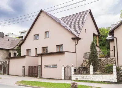 a white house with a black roof at Chill&Go Apartment in Kaunas