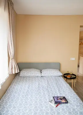 a bedroom with a bed with a book on it at Chill&Go Apartment in Kaunas