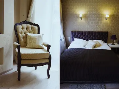 a bedroom with a bed and a chair at Taurus Apartments Vilnius in Vilnius