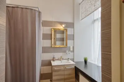 a bathroom with a sink and a mirror at Taurus Apartments Vilnius in Vilnius
