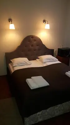 a bedroom with a large bed with two white pillows at Taurus Apartments Vilnius in Vilnius