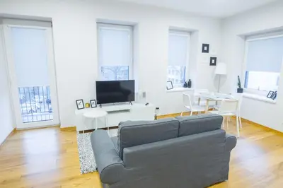 a living room with a couch and a tv at Bright 1BD Apartment in Old Town by Hostlovers in Kaunas