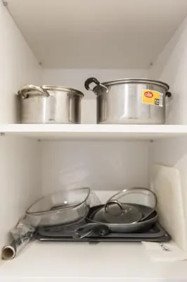 two pots and pans sitting on shelves in a refrigerator at Bright 1BD Apartment in Old Town by Hostlovers in Kaunas