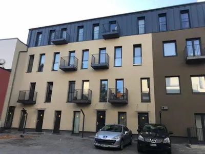 two cars parked in front of a building at Bright 1BD Apartment in Old Town by Hostlovers in Kaunas