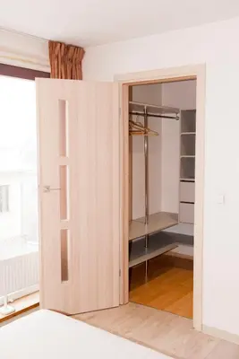 a door in a room with a closet at EVArent Apartament Free parking in Vilnius