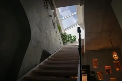 a staircase in a building with a large window at Mai Ram Yoga House in Vilnius