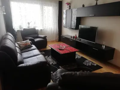 a living room with a couch and a television at Justinos Apartamentai Panevėžyje in Panevėžys