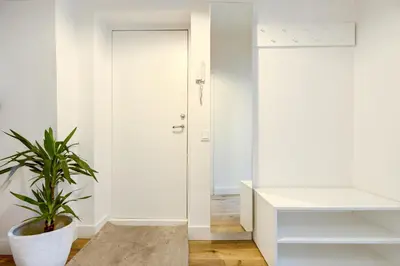 a room with a white door and a potted plant at Center Apartment, Vilnius, Old Town in Vilnius