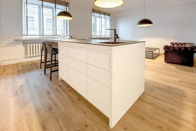 a kitchen with a white island in a room at Center Apartment, Vilnius, Old Town in Vilnius