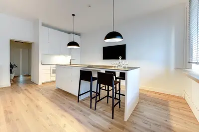 a kitchen with a island with two chairs and a counter top at Center Apartment, Vilnius, Old Town in Vilnius