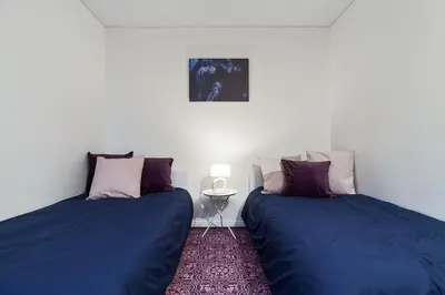two beds sitting next to each other in a room at Pušyno apartamentai in Anykščiai