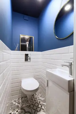 a bathroom with a white toilet and a sink at Pušyno apartamentai in Anykščiai