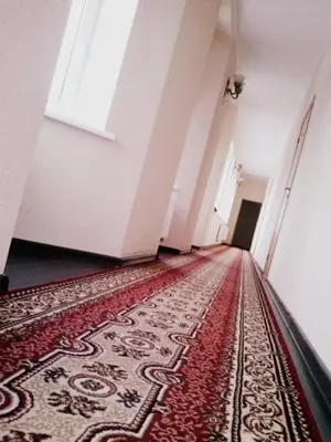 an empty hallway with a rug on the floor at Marijonu Apartments in Panevėžys