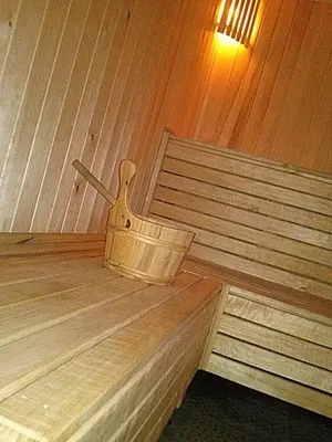 a wooden bucket sitting on top of a wooden bench at Marijonu Apartments in Panevėžys