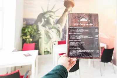 a person holding a sign in front of a statue at Hostel Liberty in Kaunas