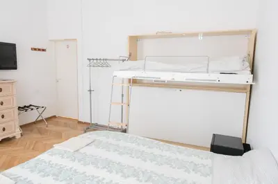 a bedroom with a bunk bed and a dresser at Hostel Liberty in Kaunas