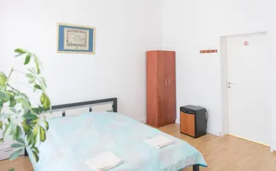 a bedroom with a bed and a tv in it at Hostel Liberty in Kaunas