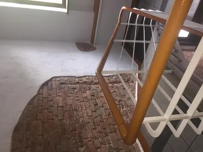 a metal staircase with a rug on the floor at Hostel Liberty in Kaunas