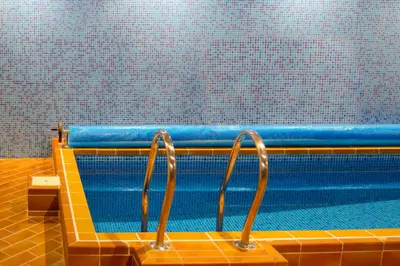 a swimming pool with two metal handles on it at Kornealita in Visaginas