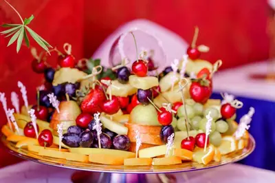 a fruit salad on a plate on a table at Kornealita in Visaginas