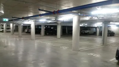 an empty parking garage with cars parked in it at Spacious apartment close to the Old Town in Vilnius