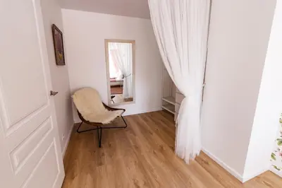 a room with a chair and a mirror at Spacious apartment close to the Old Town in Vilnius