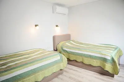two beds sitting next to each other in a room at Lofts - Kaunas airport in Karmėlava
