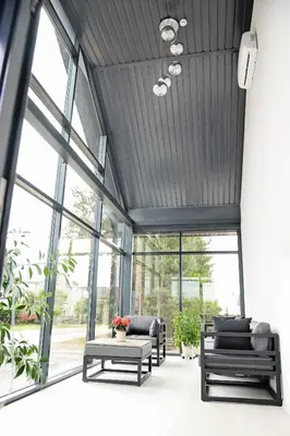 a living room with black ceilings and large windows at Lofts - Kaunas airport in Karmėlava
