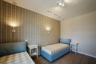 a room with two beds and two night stands at Geras miegas in Druskininkai