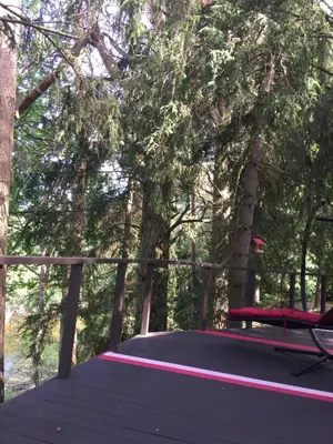 a wooden deck with a bench and trees at VIP Red Love house for 2 in Shilagalyay
