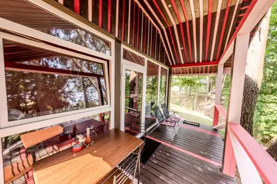a screened in porch of a house with a wooden table at VIP Red Love house for 2 in Shilagalyay