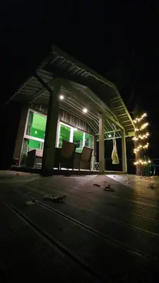 a building with chairs and lights in the dark at VIP Green House of Hope for 2 in Leliūnai