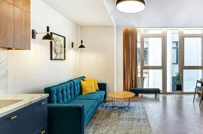 a living room with a blue couch and a table at Downtown apartment in Vilnius str. in Vilnius