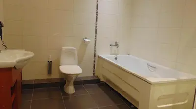 a bathroom with a tub and a toilet and a sink at Villa Alicante & SPA in Zujūnai