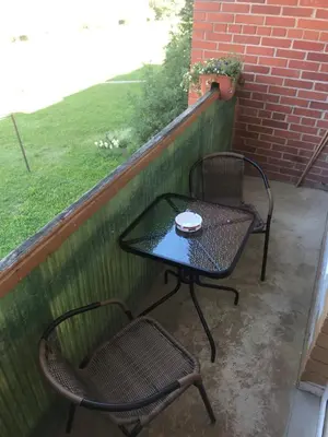 a table and two chairs sitting on a patio at Jaukus butas in Anykščiai