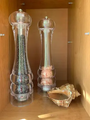 two glass vases sitting on top of a shelf at Jaukus butas in Anykščiai