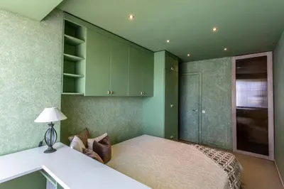 a bedroom with green cabinets and a bed in it at Gerda Apartments in Druskininkai